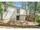 Back exterior view of home featuring a wooden deck with stairs, glass sliding door and wooded backyard at 3923 Lookout Point Dr, Marietta, GA 30066