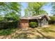 Exterior view of house screened-in porch with brick, siding, and mature trees at 404 Bridlewood Cir, Decatur, GA 30030