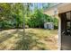 Expansive backyard with lush greenery and a storage shed, ideal for outdoor activities at 404 Bridlewood Cir, Decatur, GA 30030