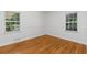 Bright bedroom with hardwood floors, white trim, and ample natural light from two windows at 404 Bridlewood Cir, Decatur, GA 30030