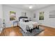 Comfortable bedroom featuring hardwood floors, white trim and light-filled windows at 404 Bridlewood Cir, Decatur, GA 30030