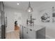 Kitchen island with gray cabinets and stone countertop featuring a vintage metal pendant light at 404 Bridlewood Cir, Decatur, GA 30030