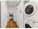 Hallway laundry closet with stacked washer/dryer and sliding barn door leading to bathroom at 404 Bridlewood Cir, Decatur, GA 30030