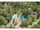 Aerial view of community pool, tennis courts, and mature trees at 5251 Amberbrook Ct, Marietta, GA 30068