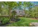 Lush backyard with manicured lawn, mature trees, a wooden fence, and a charming deck off the house at 5251 Amberbrook Ct, Marietta, GA 30068