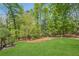 Expansive backyard features a pristine lawn and mature trees for added privacy and shade at 5251 Amberbrook Ct, Marietta, GA 30068