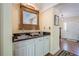 Convenient bar area with granite countertop, a sink, white cabinets and decorative mirror at 5251 Amberbrook Ct, Marietta, GA 30068