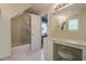 Bright bathroom featuring a glass enclosed shower, makeup vanity, and ample counter space at 5251 Amberbrook Ct, Marietta, GA 30068
