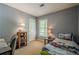 Cozy bedroom features light gray walls, a window with blinds, and charming decor at 5251 Amberbrook Ct, Marietta, GA 30068