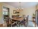 Traditional dining room with classic chandelier, wainscoting, and a large wooden table for gatherings at 5251 Amberbrook Ct, Marietta, GA 30068