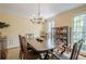 Bright dining room featuring a traditional chandelier, large windows, and classic wooden furniture at 5251 Amberbrook Ct, Marietta, GA 30068