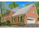 Charming brick house featuring classic architecture, mature landscaping, and an attached garage at 5251 Amberbrook Ct, Marietta, GA 30068