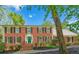 Classic brick home featuring black shutters and a vibrant green front door, set against a blue sky at 5251 Amberbrook Ct, Marietta, GA 30068