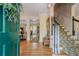 Welcoming foyer with hardwood floors, staircase with decorative spindles, and views into the living spaces at 5251 Amberbrook Ct, Marietta, GA 30068