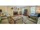 Cozy living room with a brick fireplace, plush seating, and abundant natural light from large windows at 5251 Amberbrook Ct, Marietta, GA 30068