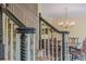 Detailed staircase featuring dark wood banisters and decorative carpet, adjacent to a formal dining room at 5251 Amberbrook Ct, Marietta, GA 30068