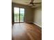 Bedroom with hardwood floors and a ceiling fan, with access to a private balcony at 795 Hammond Dr # 1908, Atlanta, GA 30328
