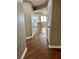Hallway with hardwood floors leading to kitchen with white cabinets and island at 795 Hammond Dr # 1908, Atlanta, GA 30328