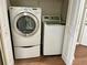 Laundry closet featuring a stacked white washer and dryer with white bi-fold doors at 795 Hammond Dr # 1908, Atlanta, GA 30328