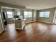 Bright living room with hardwood floors, large windows, and an open kitchen concept at 795 Hammond Dr # 1908, Atlanta, GA 30328