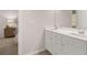 Bright bathroom with a double sink vanity with white countertops and view into the bedroom at 1348 Riverstone Rd # 106, Jonesboro, GA 30238