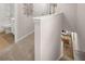 Upstairs hallway with carpet and view into the living room and second bathroom at 1348 Riverstone Rd # 106, Jonesboro, GA 30238