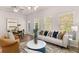 Open-concept living area with modern furniture, natural light, and dining area at 1348 Riverstone Rd # 106, Jonesboro, GA 30238