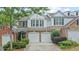Charming townhome boasts a two-car garage, well-manicured landscaping, and a classic facade with neutral tones at 1491 Bellsmith Dr, Alpharetta, GA 30076