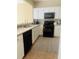 Well-maintained kitchen features white cabinetry, stainless steel appliances, and a tile backsplash at 1491 Bellsmith Dr, Alpharetta, GA 30076