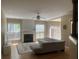 Bright living room showcasing a cozy fireplace, hardwood floors, large windows, and a comfortable sectional sofa at 1491 Bellsmith Dr, Alpharetta, GA 30076