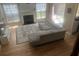 Bright living room showcasing a cozy fireplace, hardwood floors, large windows, and a comfortable sectional sofa at 1491 Bellsmith Dr, Alpharetta, GA 30076