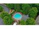 Aerial view of a community pool with lounge chairs surrounded by trees at 1491 Bellsmith Dr, Alpharetta, GA 30076