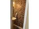 Chic powder room features a stylish vessel sink and a unique stone accent wall at 1491 Bellsmith Dr, Alpharetta, GA 30076
