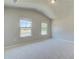 Large bedroom with plush carpeting and views of the surrounding neighborhood at 174 Haverling Pass, Hampton, GA 30252