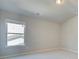 Bright bedroom features large windows for plenty of natural light and neutral paint at 174 Haverling Pass, Hampton, GA 30252
