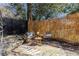 Private backyard seating area with stone patio, decorative bamboo privacy screen, and shaded from mature trees at 195 Arizona Ne Ave # 203, Atlanta, GA 30307