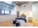 Lofted bedroom with decorative headboard, hardwood floors, and view into ensuite bathroom under skylight at 195 Arizona Ne Ave # 203, Atlanta, GA 30307
