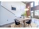 Open concept living area showcasing dining table under modern light fixture, visible brick wall, and high ceiling at 195 Arizona Ne Ave # 203, Atlanta, GA 30307