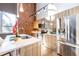 Modern kitchen with stainless steel appliances, a large island and exposed brick accent wall at 195 Arizona Ne Ave # 203, Atlanta, GA 30307