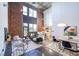 Open-concept living room with exposed brick, high ceilings, modern furnishings, and kitchen at 195 Arizona Ne Ave # 203, Atlanta, GA 30307