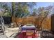 Cozy outdoor patio with table, chairs, rug, privacy screen, and mature trees at 195 Arizona Ne Ave # 203, Atlanta, GA 30307