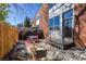 Outdoor patio area with stone ground cover, a table with chairs on a patterned rug, and brick building wall at 195 Arizona Ne Ave # 203, Atlanta, GA 30307