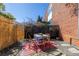Back patio dining area featuring a table and chairs on a patterned rug with a brick wall in a private outdoor setting at 195 Arizona Ne Ave # 203, Atlanta, GA 30307