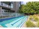 Modern lap pool, surrounded by lush greenery and privacy walls, offers a tranquil retreat at 195 Arizona Ne Ave # 203, Atlanta, GA 30307