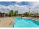 Inviting community pool surrounded by lounge chairs, lush landscaping, and clear blue skies at 195 Arizona Ne Ave # 203, Atlanta, GA 30307
