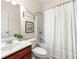 Bathroom featuring wood cabinets, white tile and a shower/tub with a white curtain at 282 Autry Mill Ln, Suwanee, GA 30024