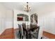 Inviting dining room with hardwood floors and views of the kitchen and stairway, creating a warm and connected living space at 282 Autry Mill Ln, Suwanee, GA 30024