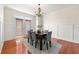 Elegant dining room with modern chandelier and hardwood floors, perfect for entertaining guests and enjoying meals at 282 Autry Mill Ln, Suwanee, GA 30024