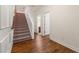 Second floor hallway with stairs, wood floors and access to the main bathroom at 282 Autry Mill Ln, Suwanee, GA 30024