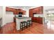 Stylish kitchen features dark wood cabinets, stainless steel appliances, and a central island, seamlessly blending functionality with elegance at 282 Autry Mill Ln, Suwanee, GA 30024